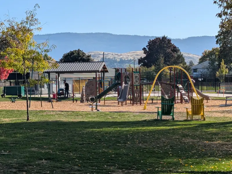 Lakeview Park playground, with the hills of the North Okanagan behind