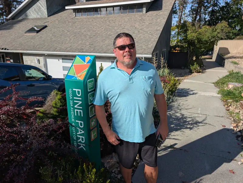 Tim Jones at the Pine Park sign, 1605A 39A Avenue
